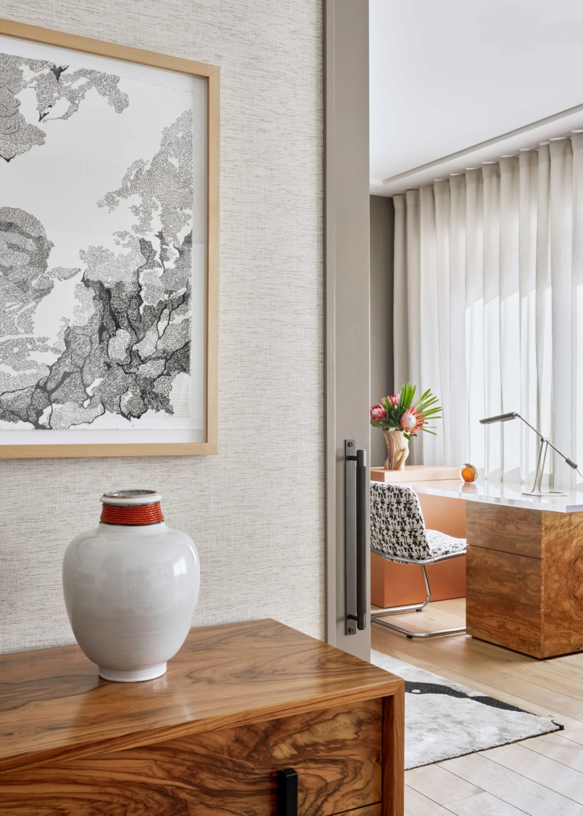 Detail view of the desk and decorative elements in the main suite with custom wood furniture.