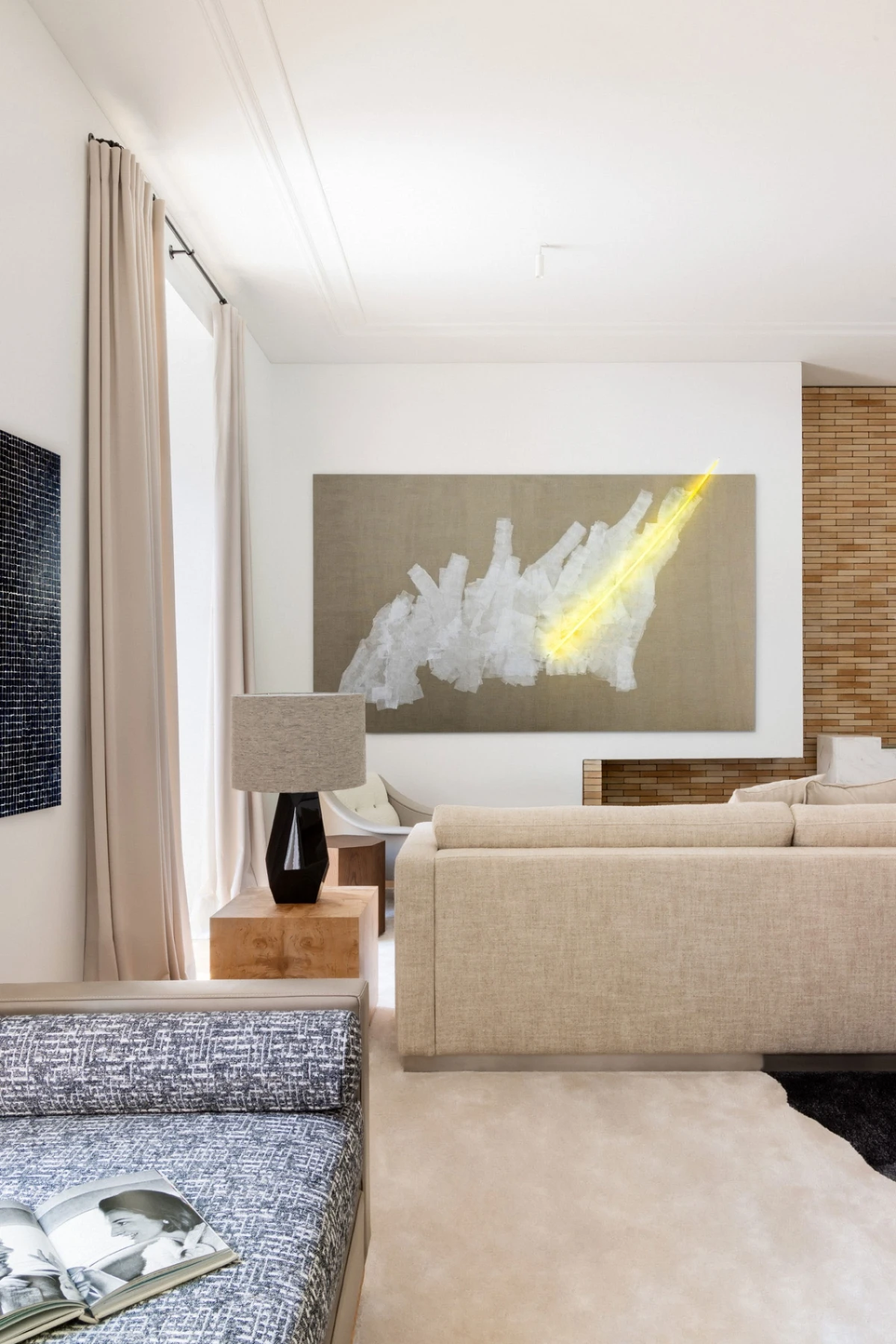 Serene living room with a contemporary interior design, neutral tones, bespoke rug in grey tones, beige sofa, wood sidetables, bespoke furniture