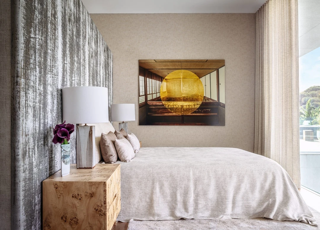 Elegant bedroom with sculptural furniture and contemporary art in luxury residence.