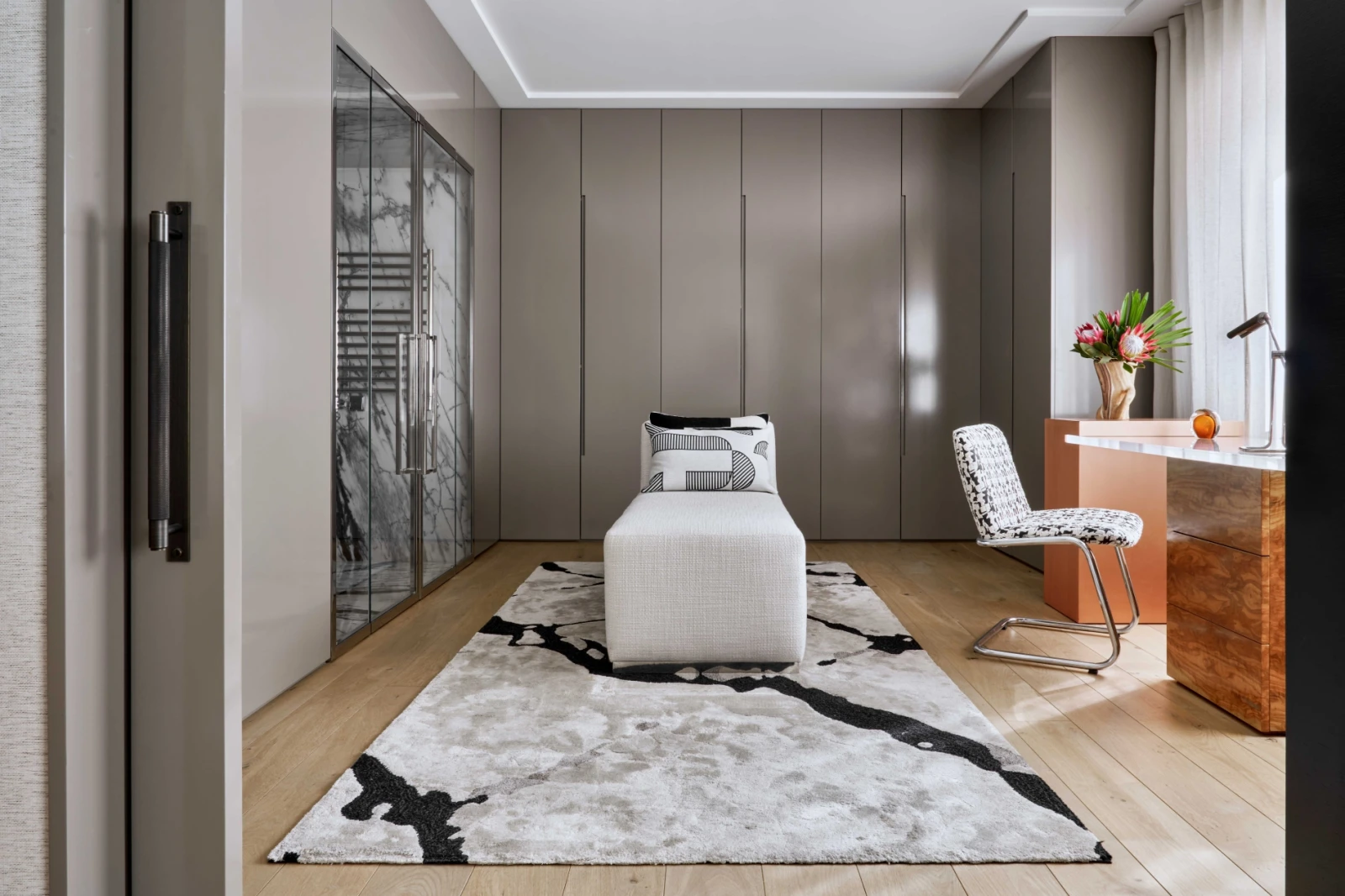 Main suite with modern closets, abstract art, and a neutral palette.